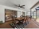Covered patio featuring a dining area with a ceiling fan, outdoor furniture, and views of the pool at 2850 Allapattah Dr, Clearwater, FL 33761