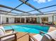 Backyard pool offers a relaxing oasis with an expansive screened enclosure and outdoor seating at 2850 Allapattah Dr, Clearwater, FL 33761
