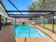 Relaxing screened-in pool with comfortable seating area, perfect for outdoor enjoyment and entertaining guests at 2850 Allapattah Dr, Clearwater, FL 33761