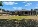 Large backyard view with screened-in lanai and mature landscaping at 3060 Sutton Woods Dr, Plant City, FL 33566