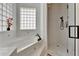 Bathtub area near glass enclosed shower at 3060 Sutton Woods Dr, Plant City, FL 33566