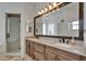 Bathroom with double sink vanity, granite countertops, large mirror and glass enclosed shower at 3060 Sutton Woods Dr, Plant City, FL 33566