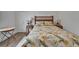 Comfortable bedroom with a decorative bedspread and two side tables featuring wood-style floors at 3060 Sutton Woods Dr, Plant City, FL 33566
