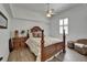 Bedroom featuring wood floors, ceiling fan, and decorative furniture at 3060 Sutton Woods Dr, Plant City, FL 33566