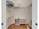 Empty closet with wood floor, wire shelves, and shoe organizer at 3060 Sutton Woods Dr, Plant City, FL 33566