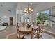 Charming dining area boasts abundant natural light, chandelier and view to foyer at 3060 Sutton Woods Dr, Plant City, FL 33566