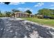 Long, paved driveway leading to the house, surrounded by well-kept lawns and landscaping at 3060 Sutton Woods Dr, Plant City, FL 33566