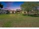 Home exterior featuring a well-manicured lawn and mature landscaping at 3060 Sutton Woods Dr, Plant City, FL 33566