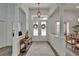 Elegant foyer featuring wood floors, chandelier, double-door entry and columns at 3060 Sutton Woods Dr, Plant City, FL 33566