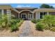 Inviting front entrance with manicured landscaping and a charming walkway at 3060 Sutton Woods Dr, Plant City, FL 33566