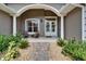 Inviting front porch featuring a seating area and a decorative double-door entrance at 3060 Sutton Woods Dr, Plant City, FL 33566
