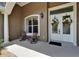 Cozy front porch with seating and a decorative double-door entrance at 3060 Sutton Woods Dr, Plant City, FL 33566