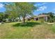 Well-manicured front lawn with mature trees and landscaping enhancing the curb appeal of the home at 3060 Sutton Woods Dr, Plant City, FL 33566