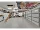 Spacious garage featuring epoxy flooring, storage cabinets, and overhead shelving at 3060 Sutton Woods Dr, Plant City, FL 33566