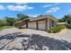 Spacious three-car garage with manicured landscaping and a paved driveway creating an inviting curb appeal at 3060 Sutton Woods Dr, Plant City, FL 33566