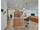 Charming kitchen with stainless steel appliances, wooden cabinets, stone counters and pendant lighting at 3060 Sutton Woods Dr, Plant City, FL 33566