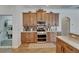 Modern kitchen featuring wooden cabinetry, stainless steel appliances and a stylish backsplash at 3060 Sutton Woods Dr, Plant City, FL 33566