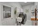 Well-lit laundry room with utility sink, washer, dryer, and a view of the garage at 3060 Sutton Woods Dr, Plant City, FL 33566
