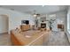 Bright living room features a fireplace, plush seating, plants and light-colored walls at 3060 Sutton Woods Dr, Plant City, FL 33566