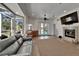 Open living area with fireplace, wet bar, wood-look tile flooring, and access to the pool at 3060 Sutton Woods Dr, Plant City, FL 33566