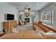 Cozy living room featuring a fireplace, large window, comfortable seating and neutral color scheme at 3060 Sutton Woods Dr, Plant City, FL 33566