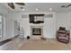 Living room showcasing a fireplace, mantle mounted television, and wood-look tile flooring at 3060 Sutton Woods Dr, Plant City, FL 33566