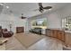 Open living room with a fireplace, lots of light and comfortable seating at 3060 Sutton Woods Dr, Plant City, FL 33566