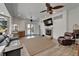 Bright living room features a fireplace, ceiling fans, and pool access at 3060 Sutton Woods Dr, Plant City, FL 33566