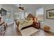Bright main bedroom with wood-look tile floors and decorative furnishings at 3060 Sutton Woods Dr, Plant City, FL 33566