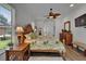 Main bedroom features wood-look tile floors, a ceiling fan, and a decorative dresser at 3060 Sutton Woods Dr, Plant City, FL 33566