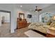 Spacious main bedroom showing wood-look tile floors and access to the ensuite bathroom at 3060 Sutton Woods Dr, Plant City, FL 33566