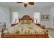 Comfortable main bedroom with tropical bedding and ample natural light at 3060 Sutton Woods Dr, Plant City, FL 33566