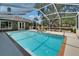 Inviting screened-in pool and spa with lush landscaping, trees, and easy access to the home at 3060 Sutton Woods Dr, Plant City, FL 33566