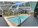 Inviting screened-in pool with steps and a handrail for easy access and lots of green space at 3060 Sutton Woods Dr, Plant City, FL 33566