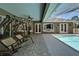 Covered patio with multiple seating areas offering views of the pool at 3060 Sutton Woods Dr, Plant City, FL 33566