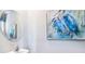 Powder room features single sink, modern faucet, round mirror, and blue heron artwork at 32429 Welling Blade Loop, Wesley Chapel, FL 33545