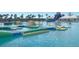 A large community pool with an inflatable obstacle course and a water slide for hours of endless fun at 32429 Welling Blade Loop, Wesley Chapel, FL 33545