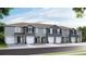 Newly constructed townhomes feature two-car garages, neutral paint, and nicely landscaped yard at 32429 Welling Blade Loop, Wesley Chapel, FL 33545