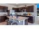 Eat-in kitchen features modern appliances, counter seating, and granite countertops at 32429 Welling Blade Loop, Wesley Chapel, FL 33545