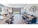 Spacious, modern living room and dining area features tile flooring and outside view at 32429 Welling Blade Loop, Wesley Chapel, FL 33545