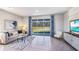 Spacious, modern living room with white sofa, patterned rug, and sliding glass doors to yard at 32429 Welling Blade Loop, Wesley Chapel, FL 33545