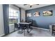 Office space features views, blue accent wall, and functional desk setup at 32429 Welling Blade Loop, Wesley Chapel, FL 33545