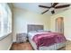 Bedroom with wood flooring, ceiling fan, and a serene atmosphere at 3292 Covered Bridge E Dr, Dunedin, FL 34698