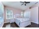 Cozy bedroom with hardwood floors, a ceiling fan, and closet space at 3292 Covered Bridge E Dr, Dunedin, FL 34698