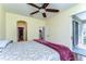 Bedroom with a sliding glass door to the lanai, ceiling fan, and lots of natural light at 3292 Covered Bridge E Dr, Dunedin, FL 34698