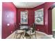 Bright breakfast nook features a glass table, metal chairs, and light fixture at 3292 Covered Bridge E Dr, Dunedin, FL 34698