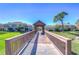 A view from the bridge in the community showing a gazebo and well maintained lawn at 3292 Covered Bridge E Dr, Dunedin, FL 34698
