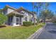 A home with an enclosed porch and a well-maintained lawn at 3292 Covered Bridge E Dr, Dunedin, FL 34698