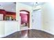 Foyer features hardwood floors, a dining area, and kitchen at 3292 Covered Bridge E Dr, Dunedin, FL 34698