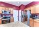 Kitchen featuring stainless steel appliances, granite countertops, and warm cabinets at 3292 Covered Bridge E Dr, Dunedin, FL 34698